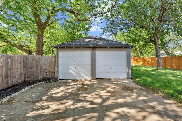 detached garage featuring fence