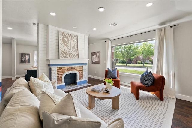 2541 NW 12th St, Oklahoma City, OK 73107 - living room featuring baseboards, recessed lighting, wood finished floors, and a fireplace