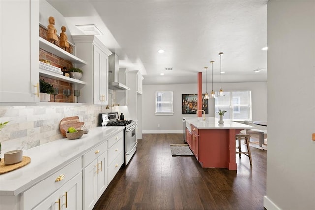 2541 NW 12th St, Oklahoma City, OK 73107 - kitchen featuring stainless steel gas range oven, wall chimney exhaust hood, open shelves, healthy amount of natural light, and recessed lighting