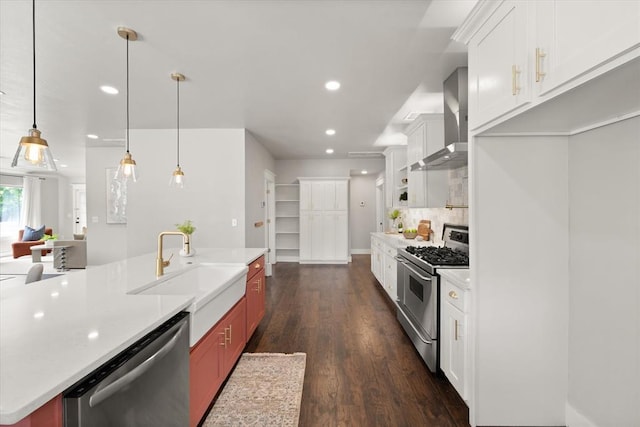 2541 NW 12th St, Oklahoma City, OK 73107 - kitchen featuring appliances with stainless steel finishes, wall chimney range hood, a sink, dark wood-type flooring, and light countertops