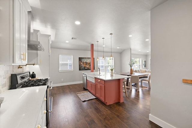 2541 NW 12th St, Oklahoma City, OK 73107 - kitchen featuring appliances with stainless steel finishes, a sink, dark wood finished floors, backsplash, and wall chimney exhaust hood