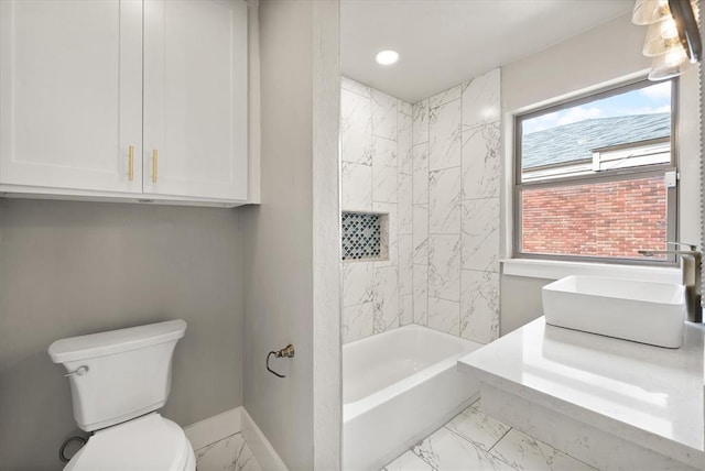 2541 NW 12th St, Oklahoma City, OK 73107 - bathroom featuring marble look tile flooring, a sink, toilet, baseboards, and tub / shower combination