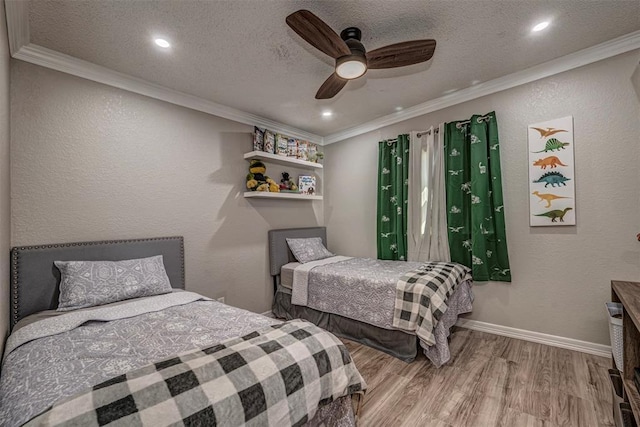 bedroom featuring crown molding, wood finished floors, and a textured ceiling