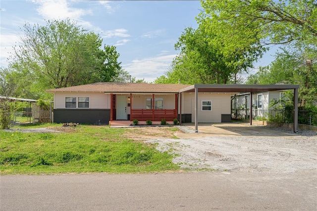 3210 SE 16th St, Oklahoma City, OK 73115 - view of front facade with dirt driveway and an attached carport