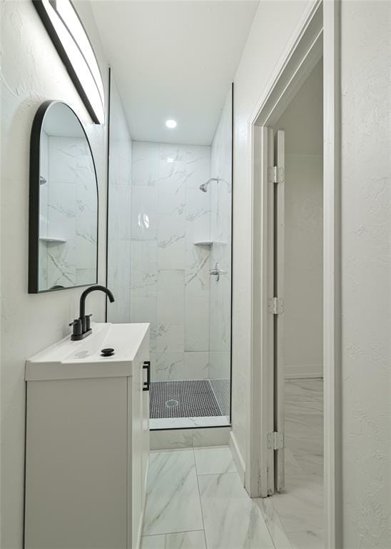 3210 SE 16th St, Oklahoma City, OK 73115 - bathroom with marble look tile flooring, a shower stall, and vanity