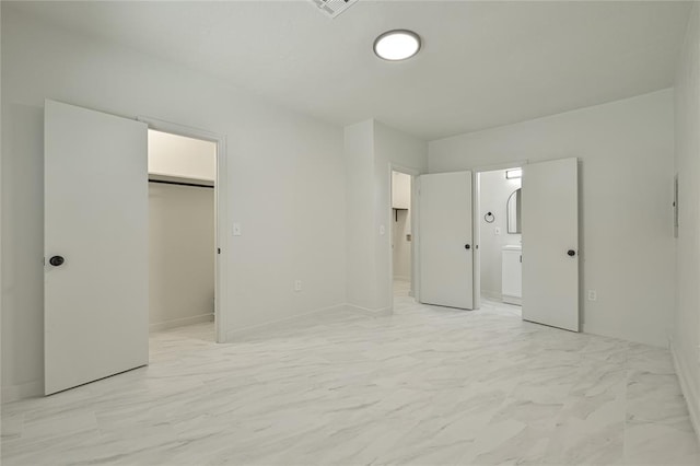 3210 SE 16th St, Oklahoma City, OK 73115 - unfurnished bedroom featuring ensuite bathroom, a spacious closet, and light marble finish flooring