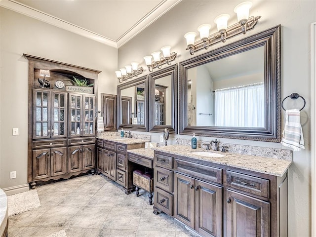 full bathroom with crown molding, double vanity, and a sink
