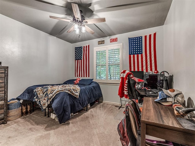 carpeted bedroom with a ceiling fan and baseboards