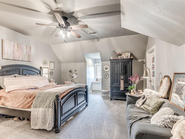 bedroom featuring ceiling fan, visible vents, baseboards, lofted ceiling, and light carpet