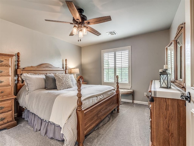 bedroom with baseboards, ceiling fan, light carpet, and visible vents