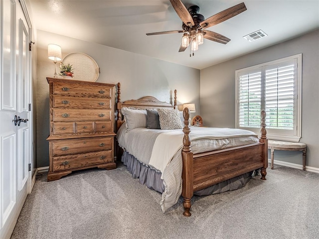 bedroom with visible vents, a ceiling fan, baseboards, and carpet floors