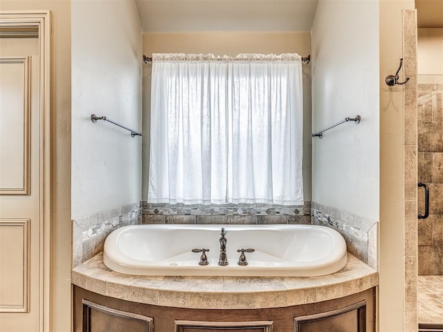 full bath featuring a shower stall and a bath