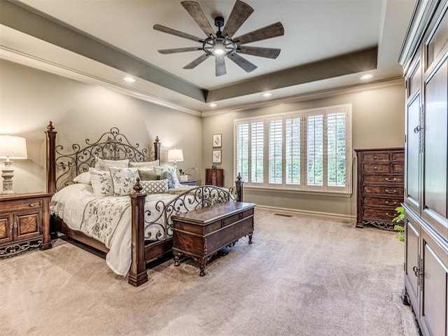 carpeted bedroom featuring crown molding, a raised ceiling, baseboards, and recessed lighting