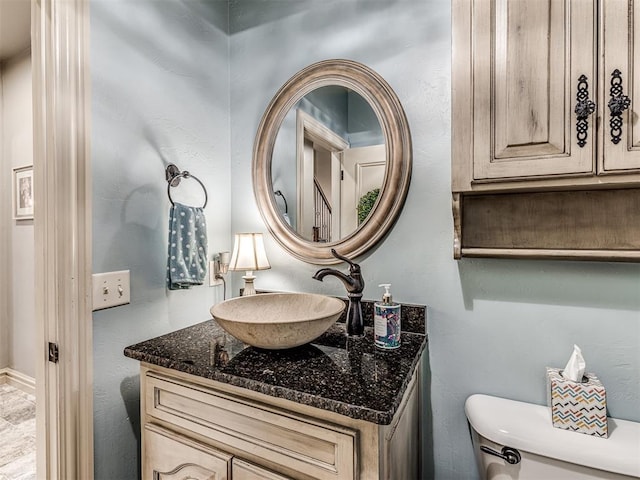 bathroom with toilet and vanity