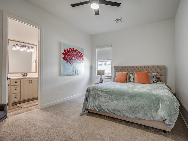 9401 Autumn Park Ln, Oklahoma City, OK 73151 - carpeted bedroom featuring a ceiling fan, visible vents, a sink, baseboards, and connected bathroom