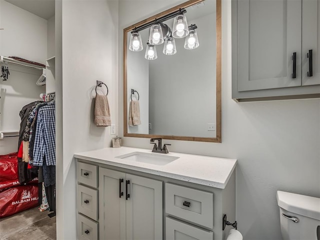 9401 Autumn Park Ln, Oklahoma City, OK 73151 - bathroom with vanity, a walk in closet, and toilet