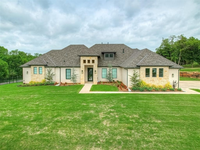 9401 Autumn Park Ln, Oklahoma City, OK 73151 - prairie-style home with fence, a shingled roof, stone siding, and a front lawn