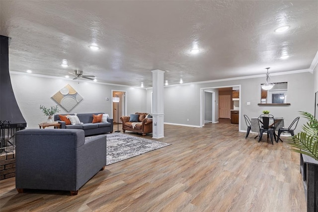 1312 N Nail Pkwy, Moore, OK 73160 - living room with wood finished floors, ornamental molding, ceiling fan, ornate columns, and recessed lighting