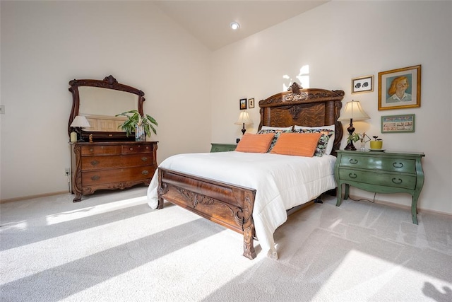 carpeted bedroom with baseboards and vaulted ceiling