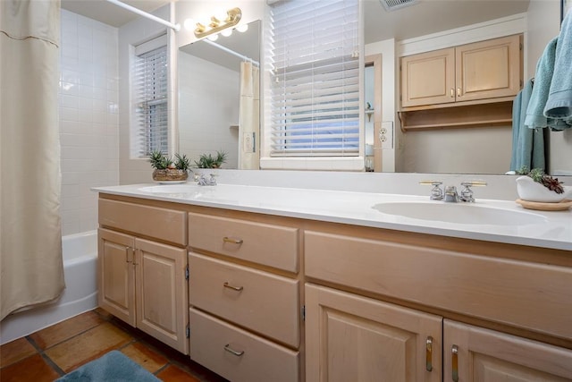 bathroom featuring double vanity, visible vents, a sink, and shower / tub combo