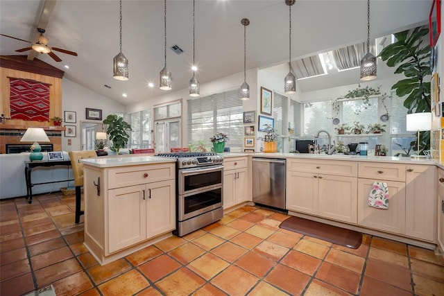 kitchen featuring stainless steel appliances, open floor plan, plenty of natural light, and a peninsula