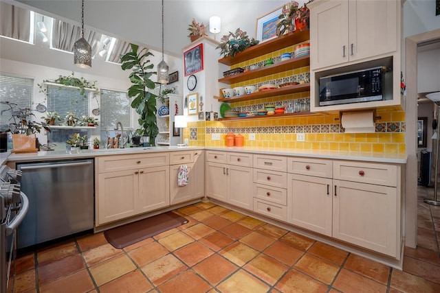 kitchen featuring backsplash, open shelves, appliances with stainless steel finishes, and light countertops