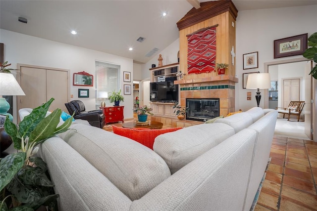 living room with recessed lighting, lofted ceiling, and a fireplace