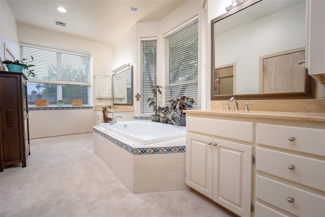 full bath featuring vanity, a garden tub, recessed lighting, and visible vents