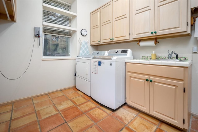 clothes washing area featuring cabinet space and washing machine and clothes dryer