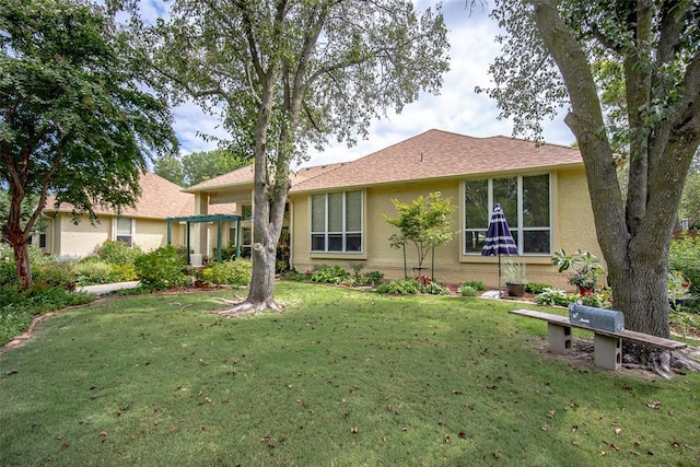 rear view of property featuring a lawn