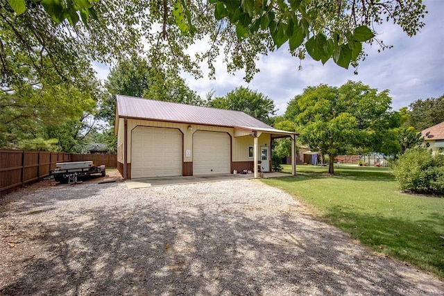 detached garage featuring fence