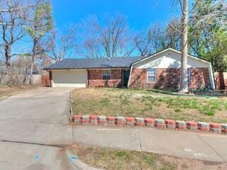 ranch-style house with driveway and a garage
