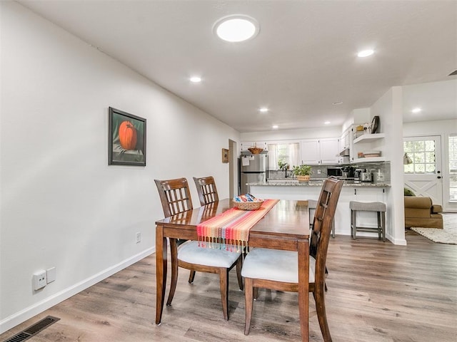dining area with a healthy amount of sunlight, recessed lighting, light wood-style flooring, and visible vents