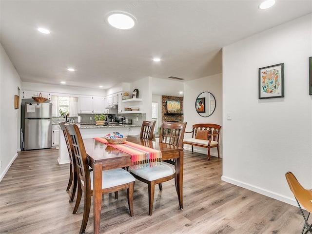 dining area featuring light wood-style floors, recessed lighting, and visible vents