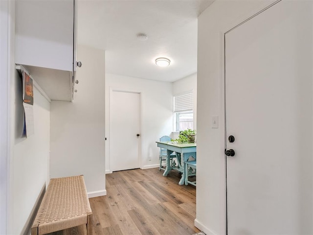 mudroom featuring baseboards and light wood-style flooring