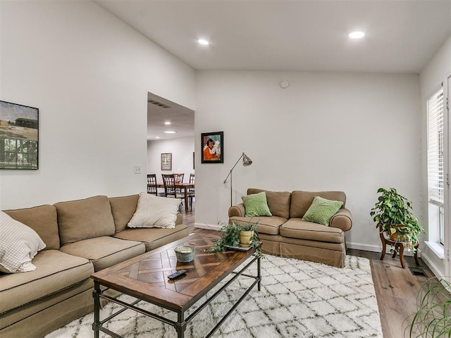 living room with recessed lighting, baseboards, visible vents, and wood finished floors