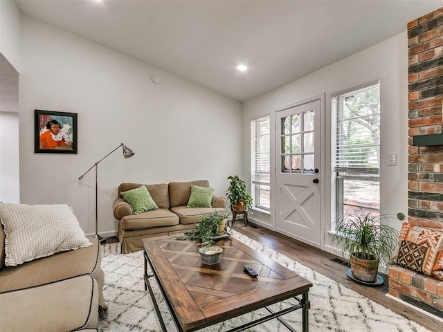living room with recessed lighting, baseboards, lofted ceiling, and wood finished floors