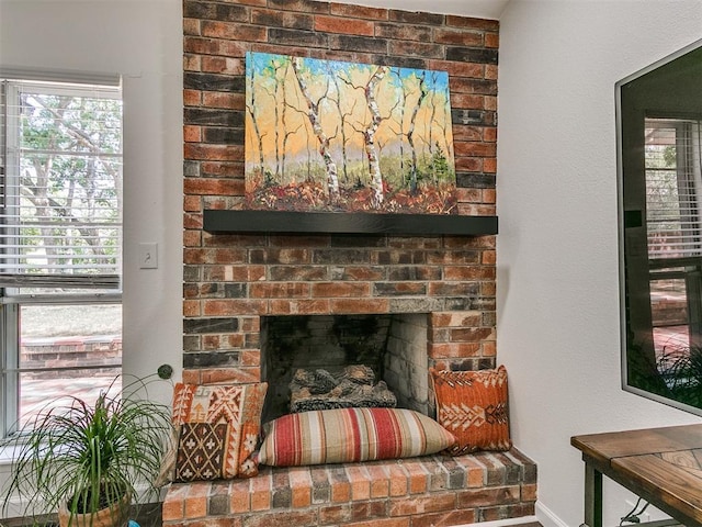 interior details featuring baseboards and a fireplace