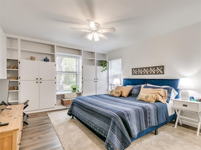bedroom with light wood finished floors and ceiling fan
