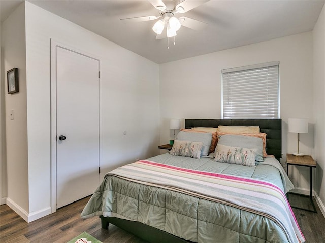 bedroom featuring a ceiling fan, baseboards, and wood finished floors