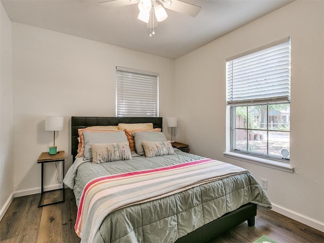 bedroom featuring baseboards, ceiling fan, and wood finished floors