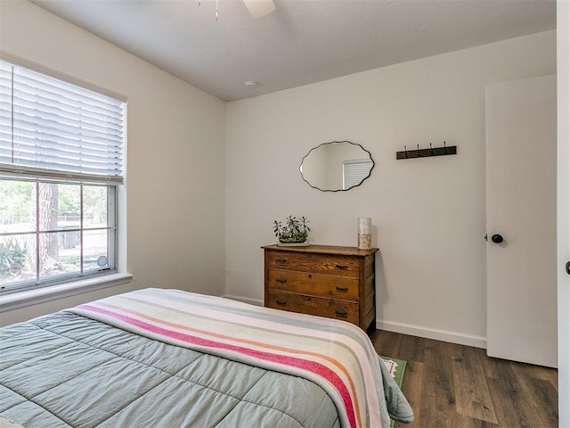bedroom featuring baseboards, a ceiling fan, and wood finished floors