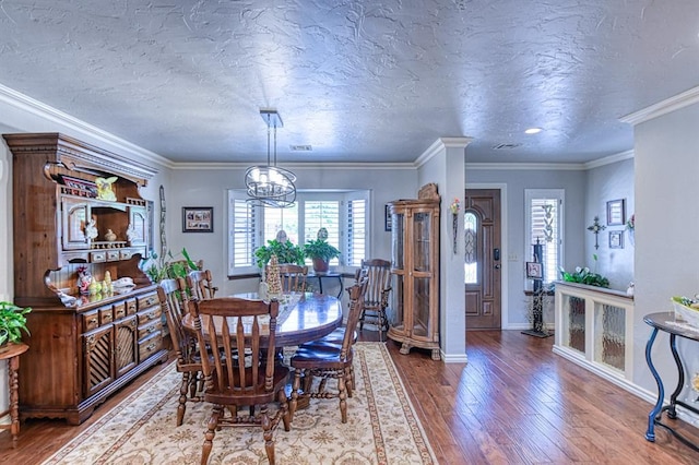 dining space with a notable chandelier, a healthy amount of sunlight, and hardwood / wood-style floors