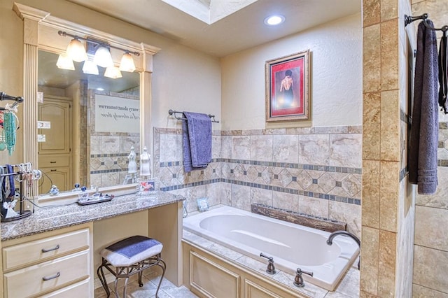 full bathroom featuring vanity, recessed lighting, a bath, and tile walls