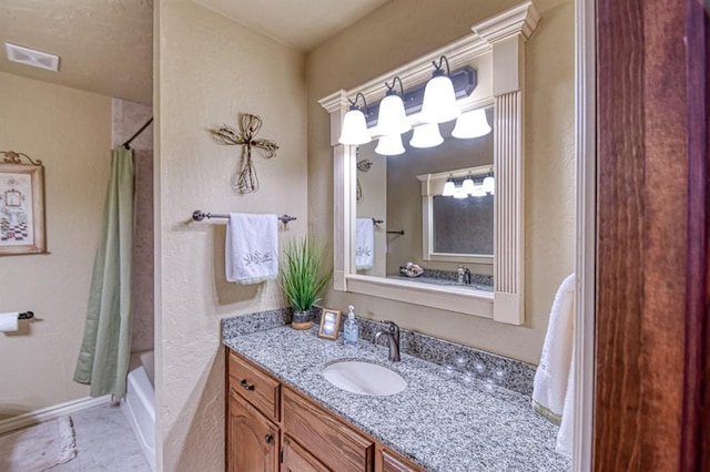 full bathroom with visible vents, tile patterned flooring, vanity, baseboards, and shower / tub combo