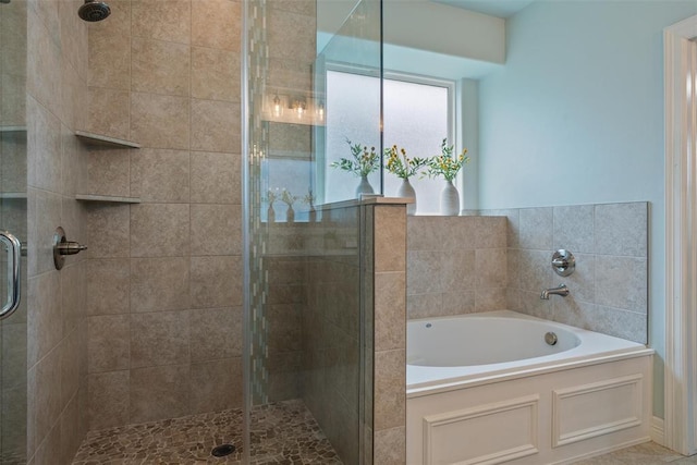 bathroom with a bath and a stall shower