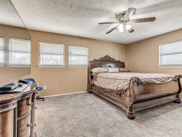 bedroom featuring a ceiling fan, baseboards, carpet, and a textured ceiling