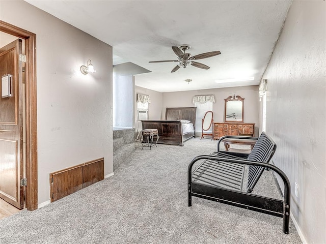 interior space featuring ceiling fan, baseboards, and carpet