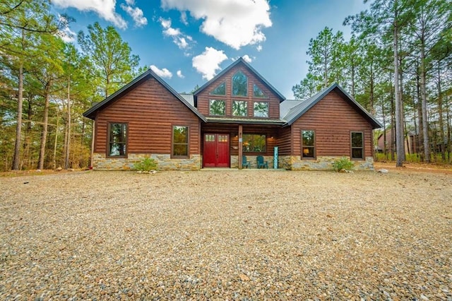 312 Sugar Pine Loop, Broken Bow, OK 74728 - back of house featuring covered porch, faux log siding, and stone siding