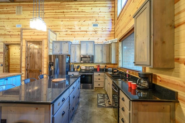 312 Sugar Pine Loop, Broken Bow, OK 74728 - kitchen featuring pendant lighting, a sink, appliances with stainless steel finishes, wood walls, and a center island